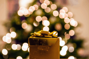 gold present under a Christmas tree