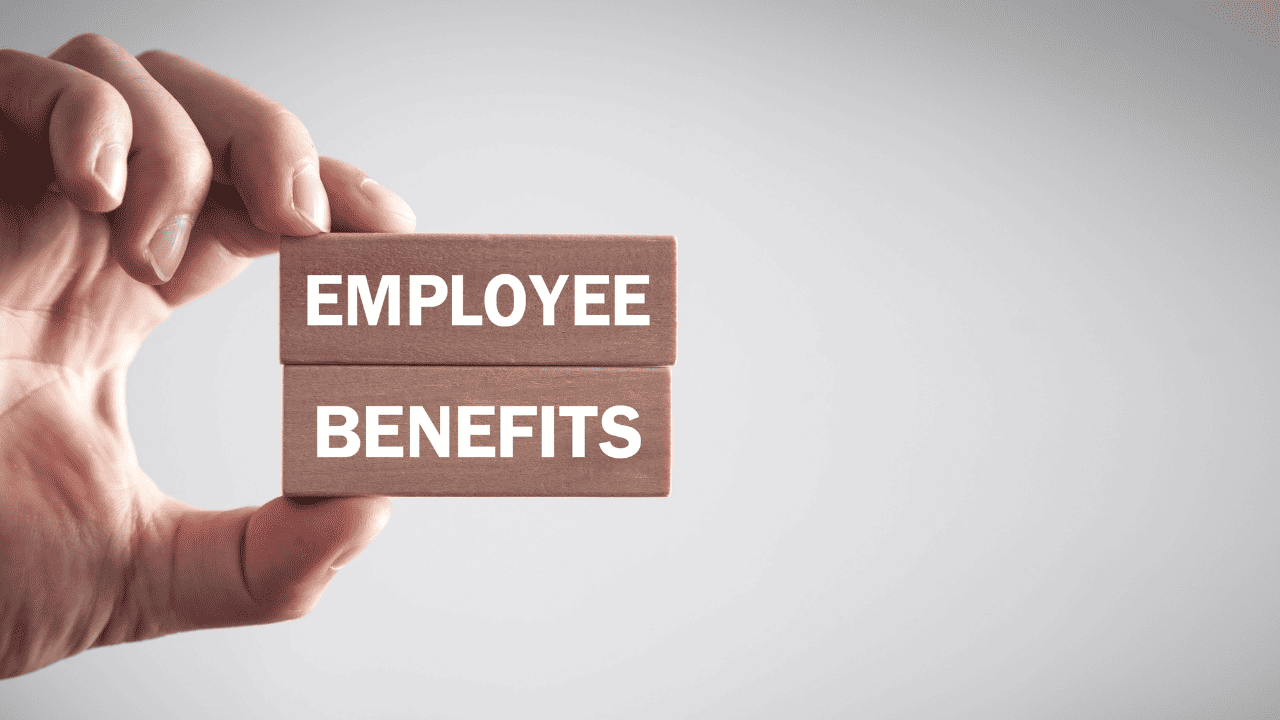 Employee benefits written on a wooden block